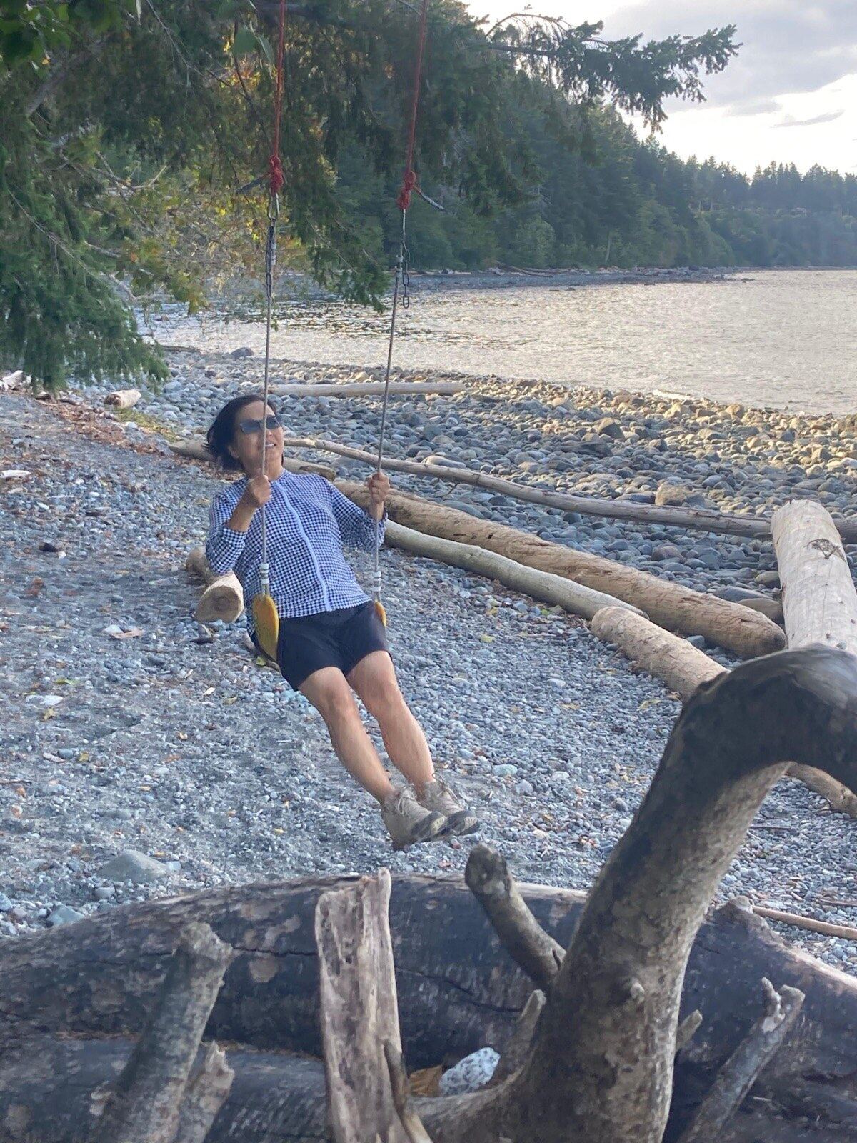 Terry on a rope swing at the beach in Maine